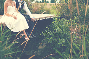 Bride and groom looking out onto a pond after discussing wedding wellbeing