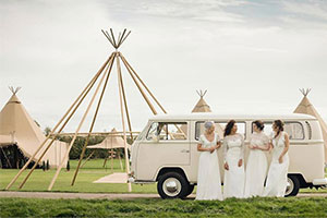 Couple in front of camper van at wedding fair