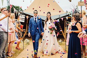 Couple having confetti thrown over them after getting married