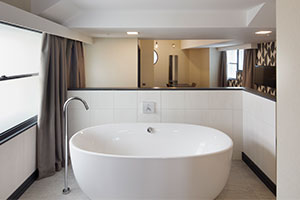 Roomzzzz aparthotels are ideal for a stag or hen party - bathroom with freestanding bath