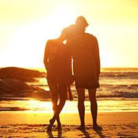 Couple stood watching sunset