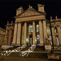 Candles lighting the steps up to an entrance of a wedding venue at night